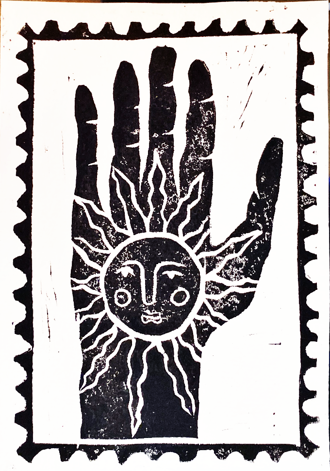 Linoleum print of a hand with a sun face